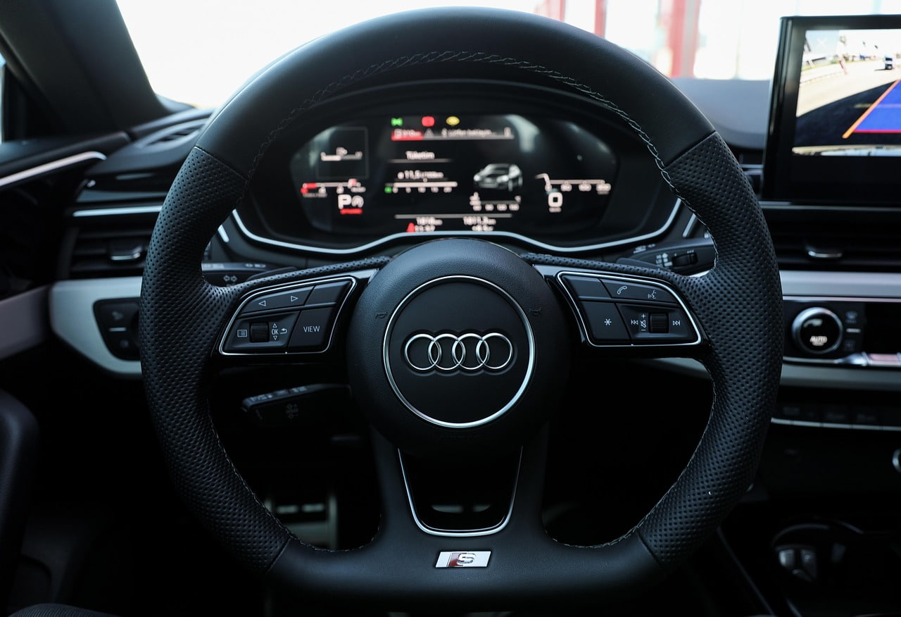 Are people at Audi being kept on by pay cuts?